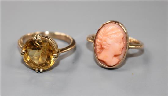 A yellow metal and coral oval cameo ring and a 9ct and citrine set ring. Cameo ring size F, Citrine ring size F